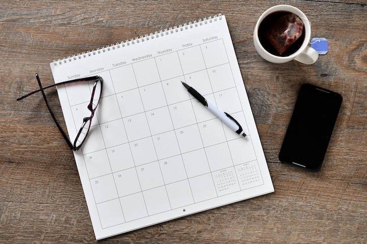 Overhead flat lay view of calendar phone pen sch 2023 11 27 05 15 37 utc